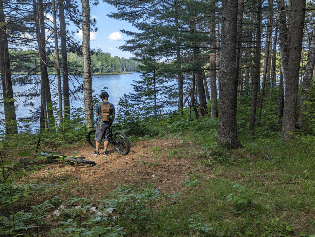 Biking in the woods near lake. 