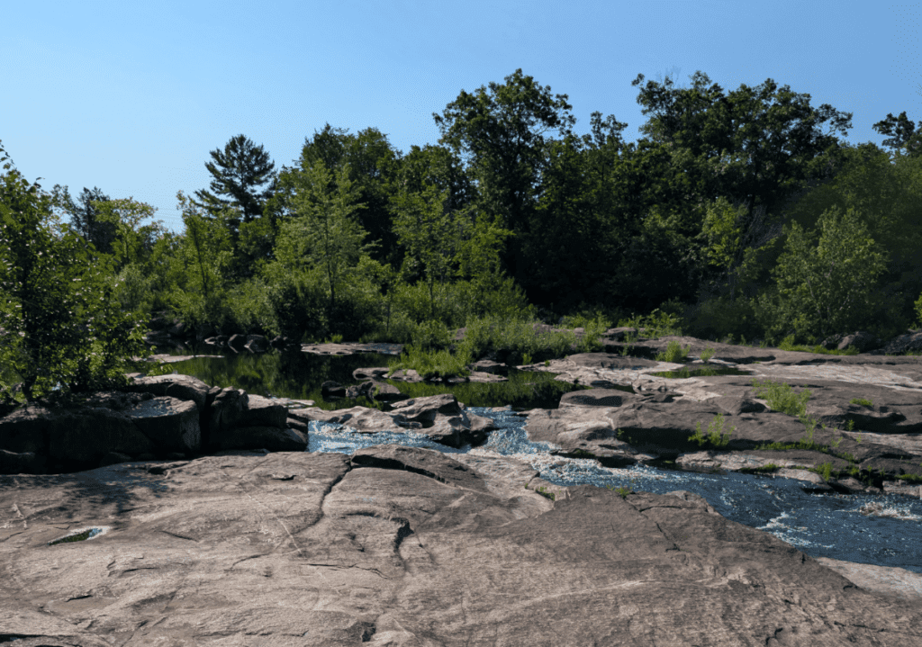 River rapids with stone outcroppings. 